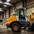 Earth mover in the garbage dump with female driver