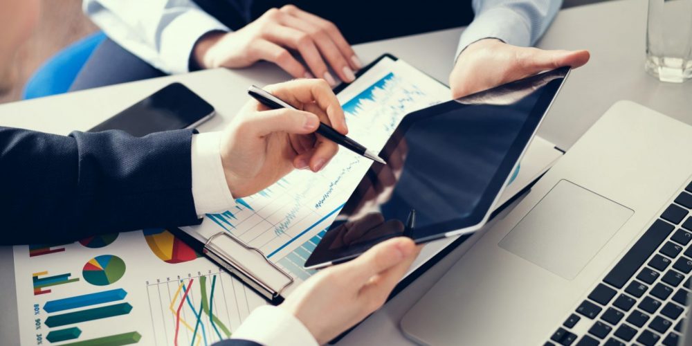 Businessman and businesswoman uses digital tablet